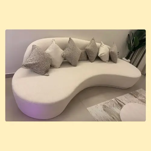 Luxury beige curved sofa with soft supportive cushions, durable frame, and modern design in Abu Dhabi