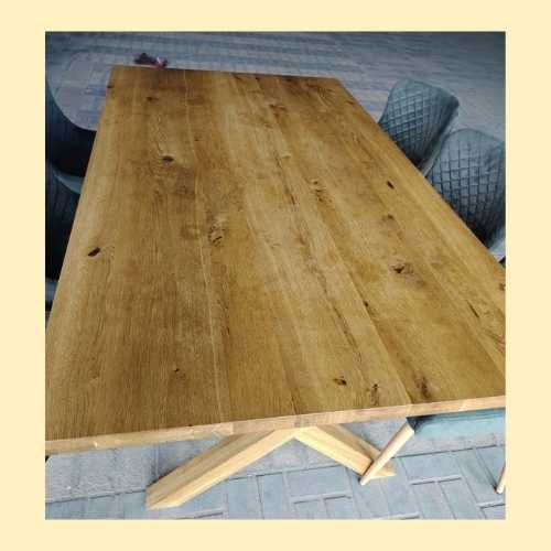Used wooden dining table and cushioned chairs for home dining