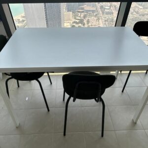 Modern used dining table with four chairs available for sale in Abu Dhabi.