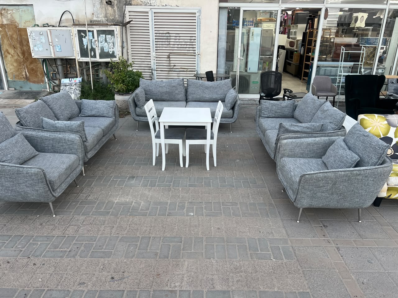 Modern grey fabric used sofa set in Abu Dhabi with chrome legs displayed